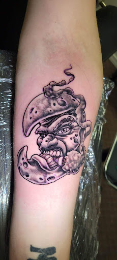 Explore bicep tattoo ideas for men, creative tattoo ideas in Angola, available at Hoodlum Ink