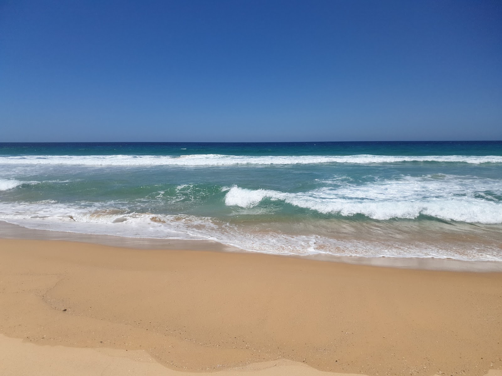 Foto van Wairo Beach gelegen in een natuurlijk gebied