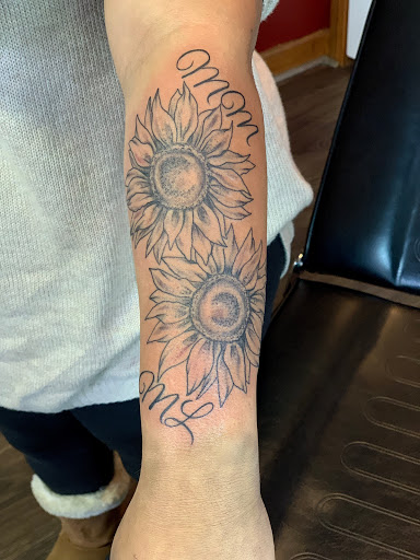 Explore rose hand tattoo ideas, creative tattoo ideas in Sanford, available at Hudson & Company Tattoo Studio