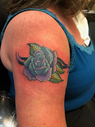 Explore colored tattoo ideas for men, creative tattoo ideas in Barre, available at Bury The Needle Tattoo