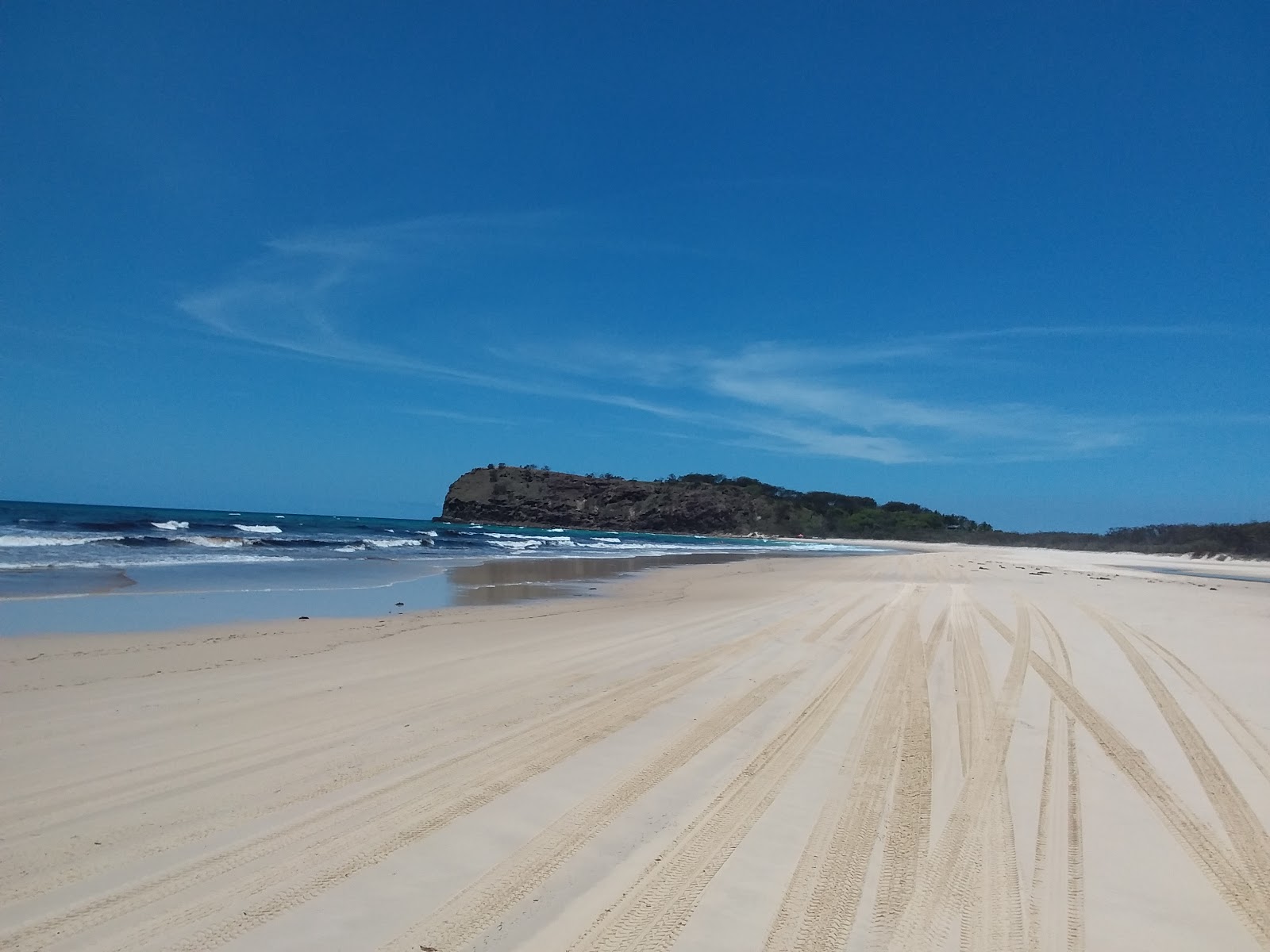 Orchid Beach的照片 带有碧绿色纯水表面