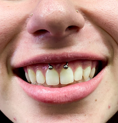 Explore inside lip tattoo ideas, creative tattoo ideas in Orange, available at Symbiosis Body Piercing