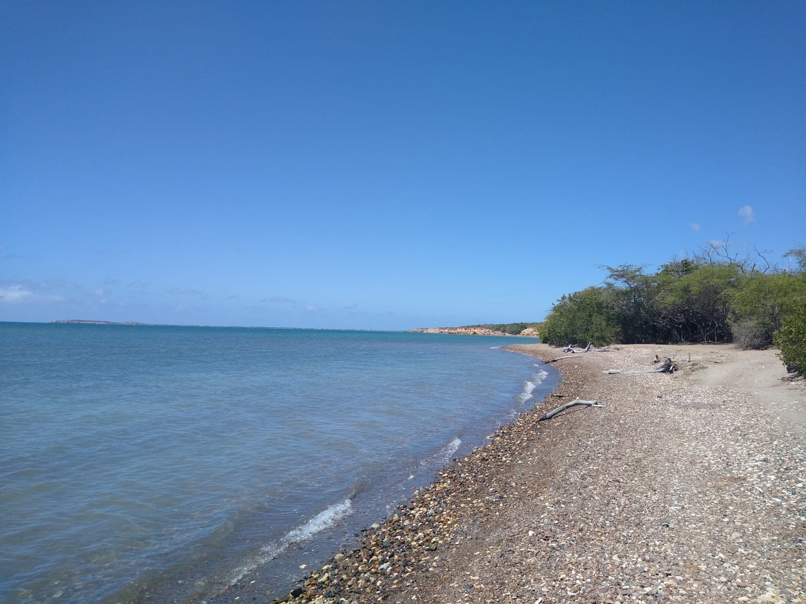 Photo of Playa Pitahaya with gray sand &  pebble surface