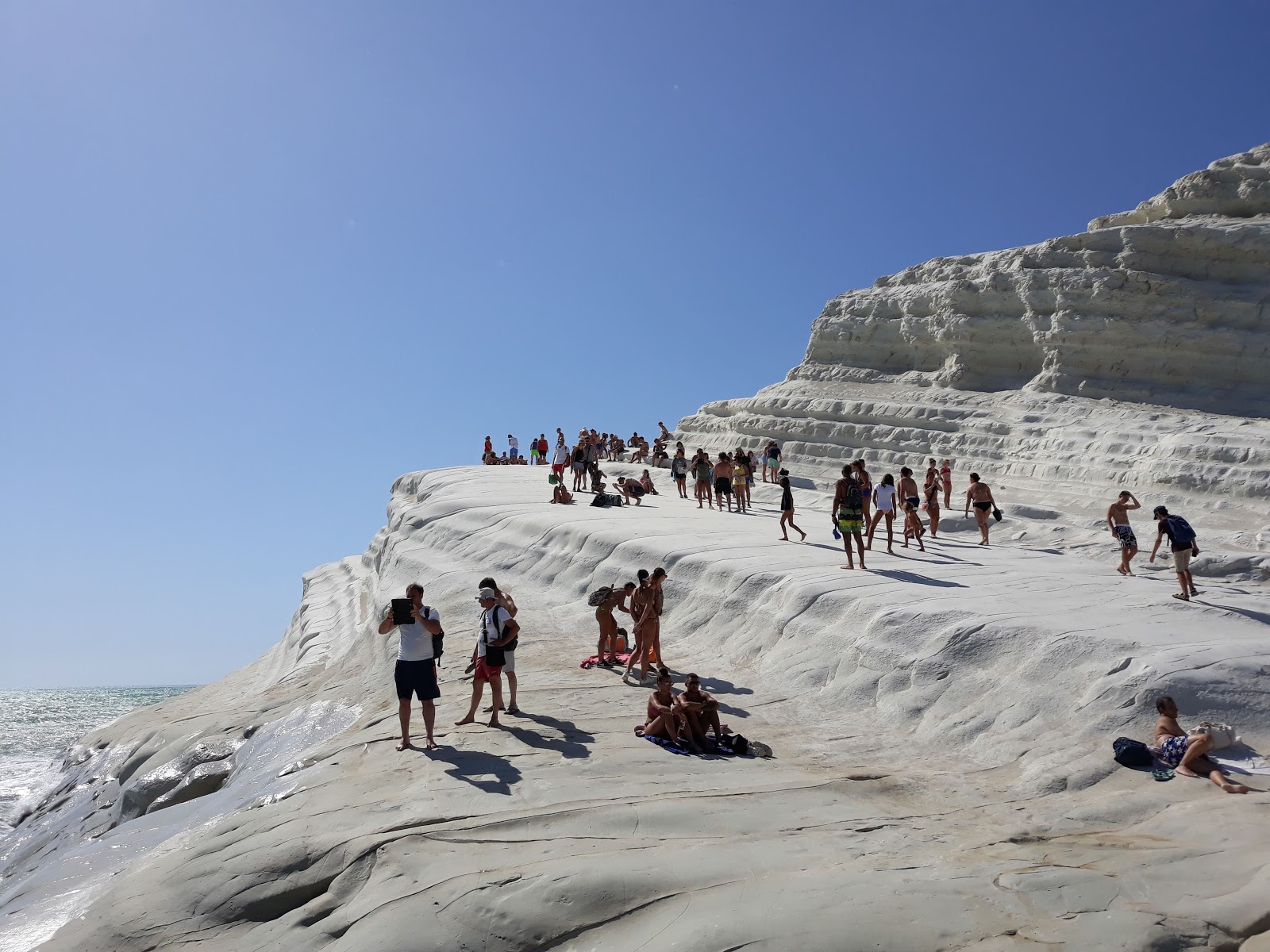 Photo of Scala dei Turchi surrounded by mountains