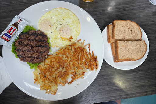 Traditional breakfast with hamburger patty. 