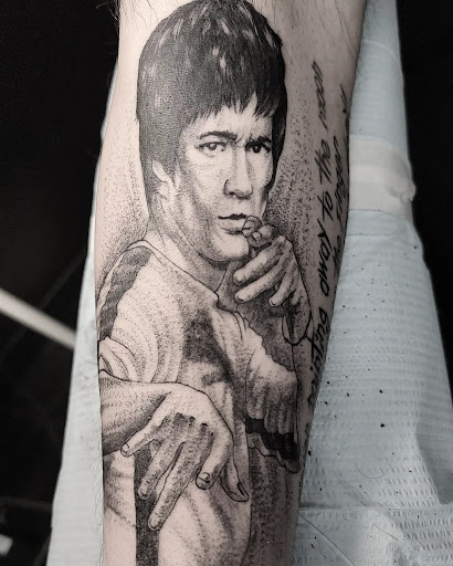 Explore rock tattoo ideas, creative tattoo ideas in Fort Myers, available at HOWL Tattoo & Piercing