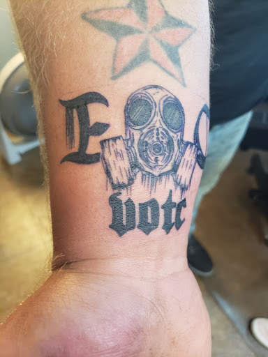 Explore blackout hand tattoo ideas, creative tattoo ideas in Elkhart, available at Divine Tattoo and Body Piercing