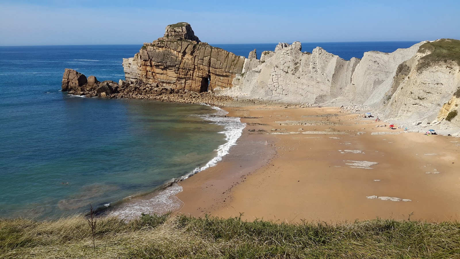 Photo of Playa de Portio with blue pure water surface