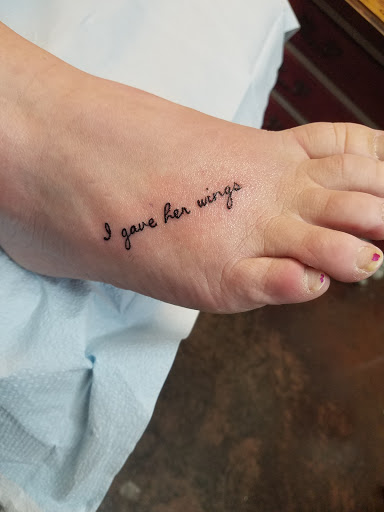 Explore dark skin male black skin tattoo ideas, creative tattoo ideas in Rockford, available at Delicious Ink Tattoo & Piercing