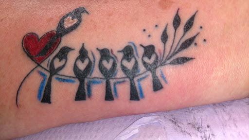 Explore tattoo ideas on belly, creative tattoo ideas in Wilson, available at Sacred Flame Tattooing & Body