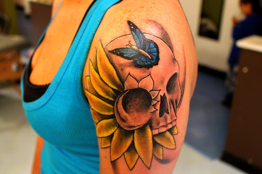 Explore skull and rose tattoo ideas, creative tattoo ideas in Dayton, available at Uppity Tattoos