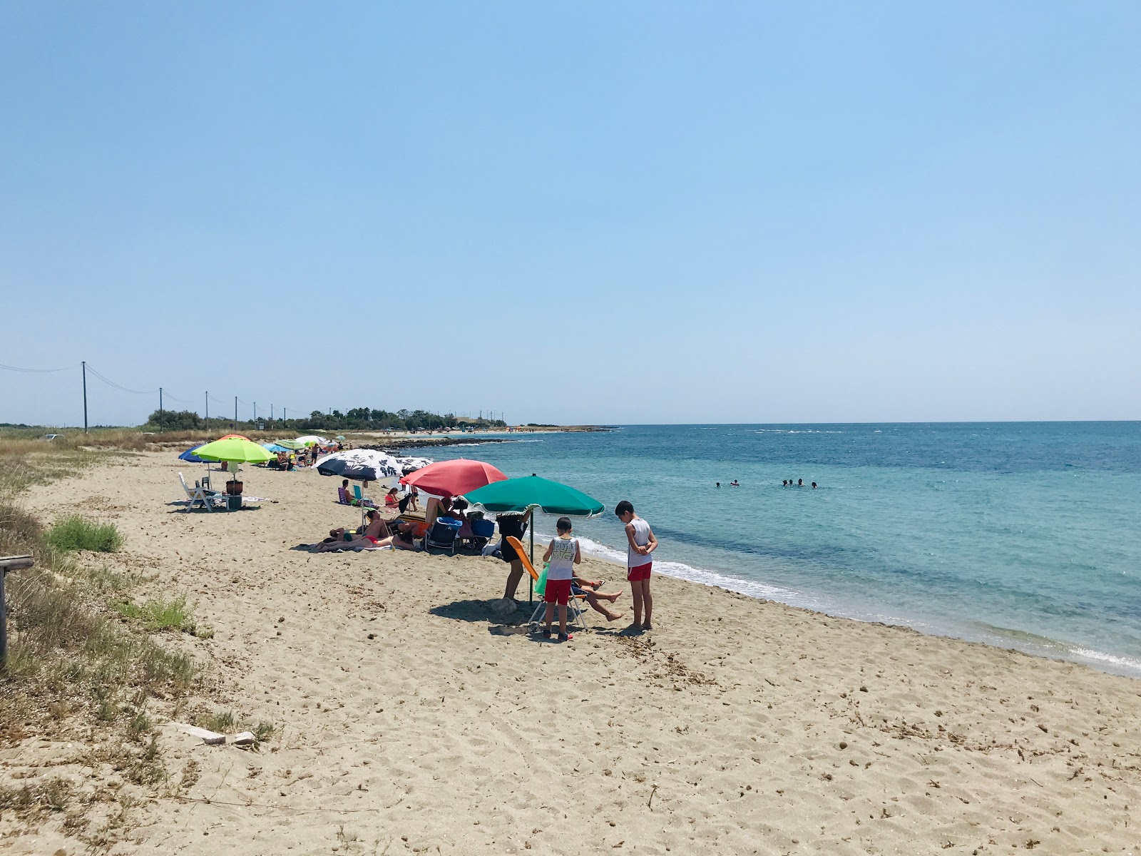 Foto af beach of Paduli med lys sand overflade