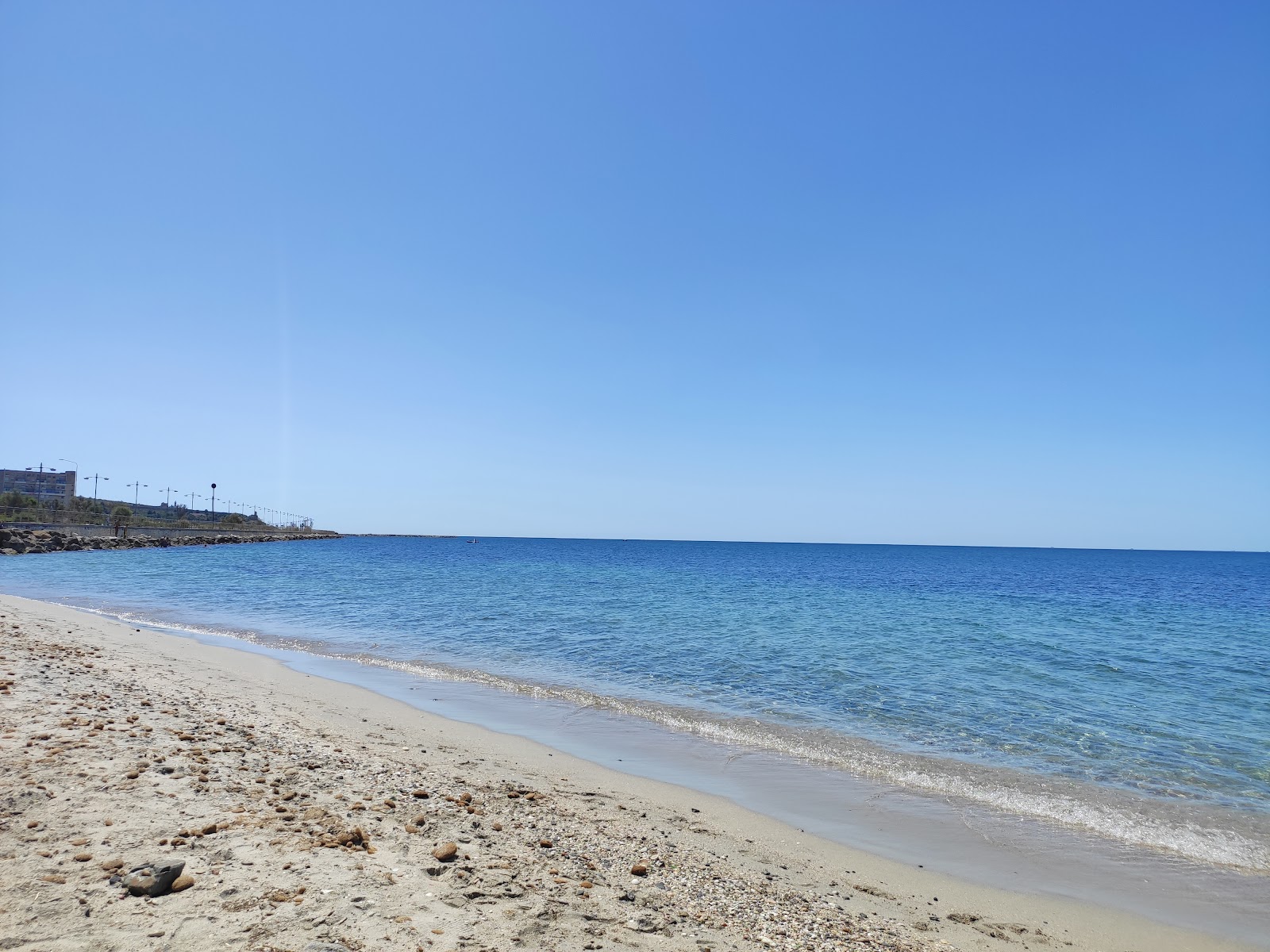 Foto van Spiaggia della Diga met blauw puur water oppervlakte
