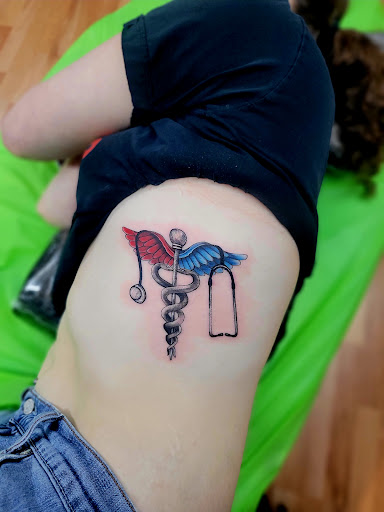 Explore lily flower tattoo ideas, creative tattoo ideas in Benton, available at Spectrum Tattoo