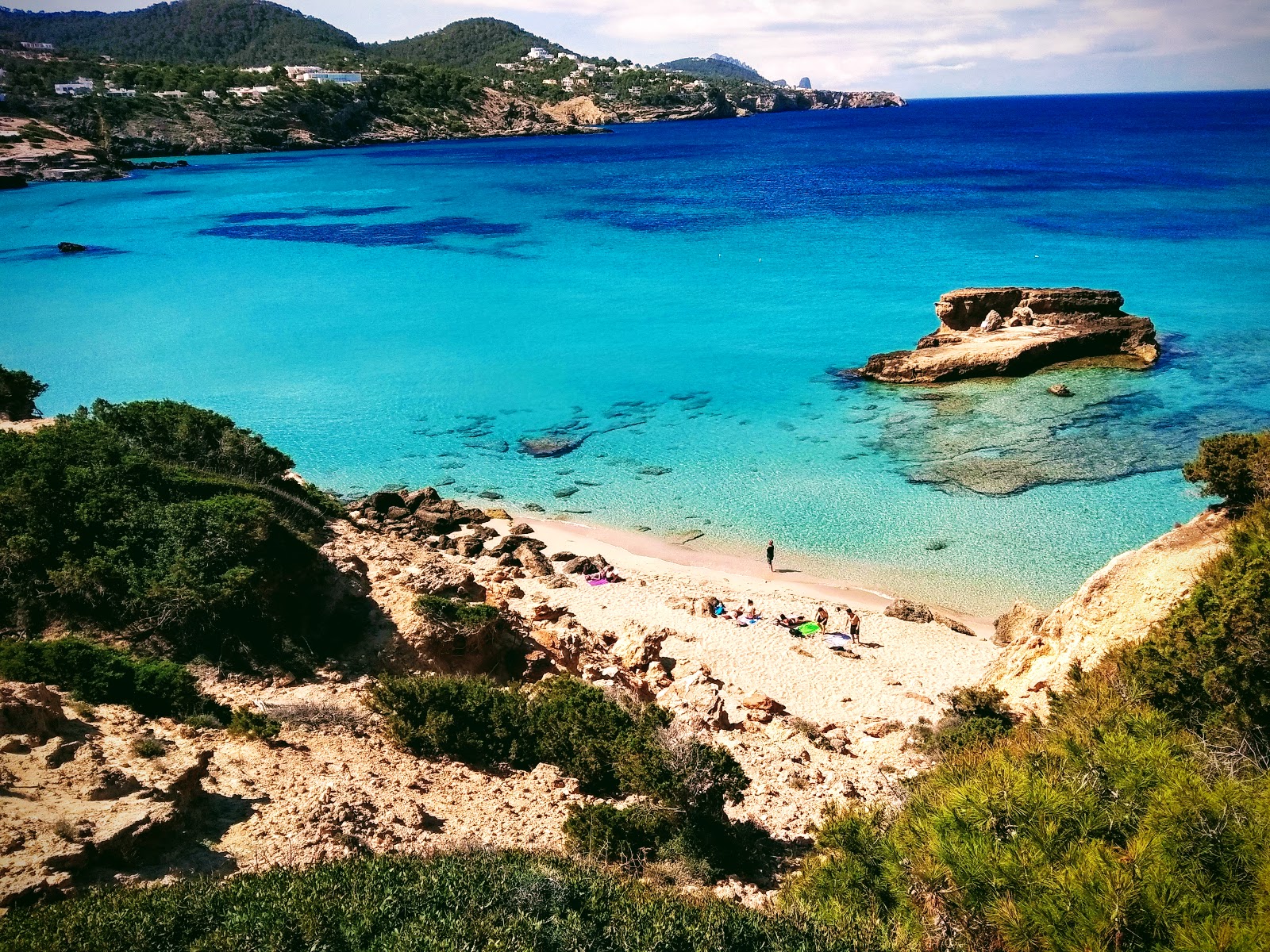 Photo of Cala Tarida pequena with turquoise pure water surface