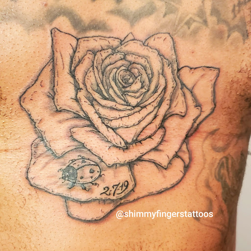 Explore knee tattoo ideas for woman, creative tattoo ideas in Jamaica, available at Shimmy Fingers Ink Tattoos