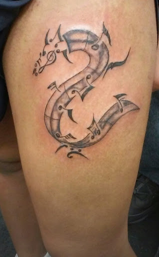 Explore guitarist tattoo ideas, creative tattoo ideas in Jamaica, available at Shimmy Fingers Ink Tattoos
