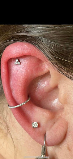 Explore thigh tattoo ideas for females, creative tattoo ideas in Kirksville, available at Properly Pierced