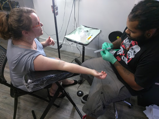 Explore bookworm tattoo ideas, creative tattoo ideas in Atlanta, available at Iron Palm Tattoos & Body Piercing Atlanta