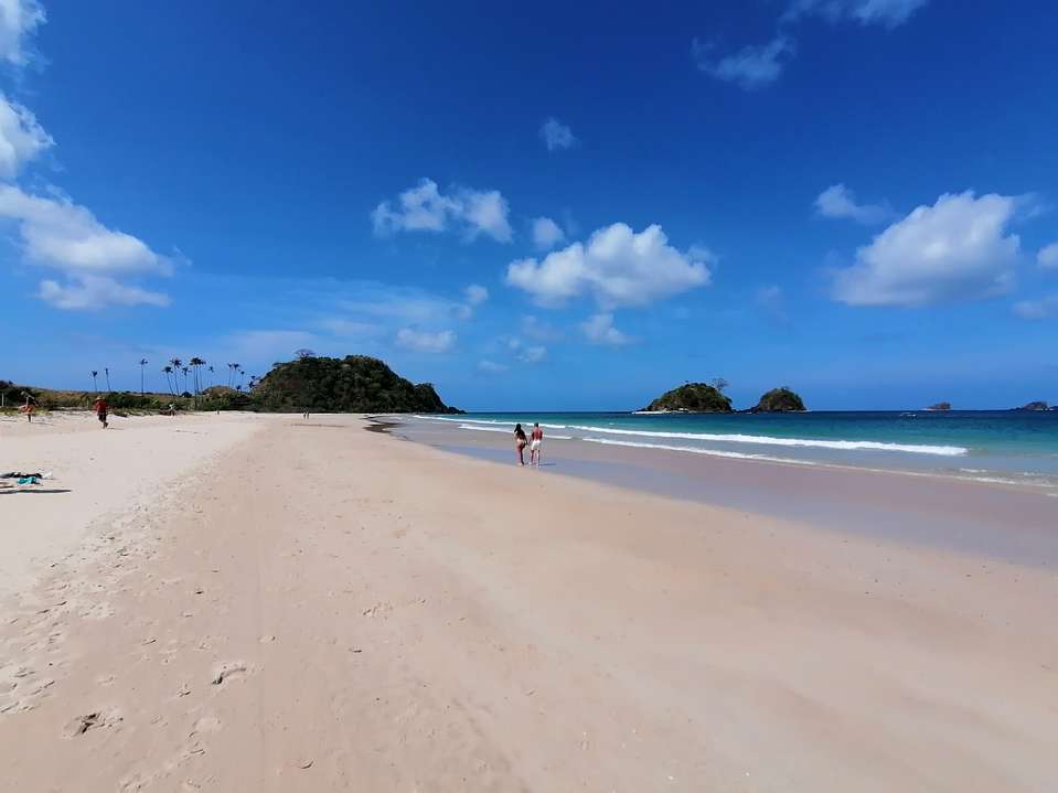 Photo of Nacapan Beach with long straight shore