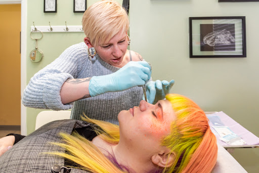 Find tattoo ideas between breast for your next unique tattoo in Albuquerque at Evolution Body Piercing