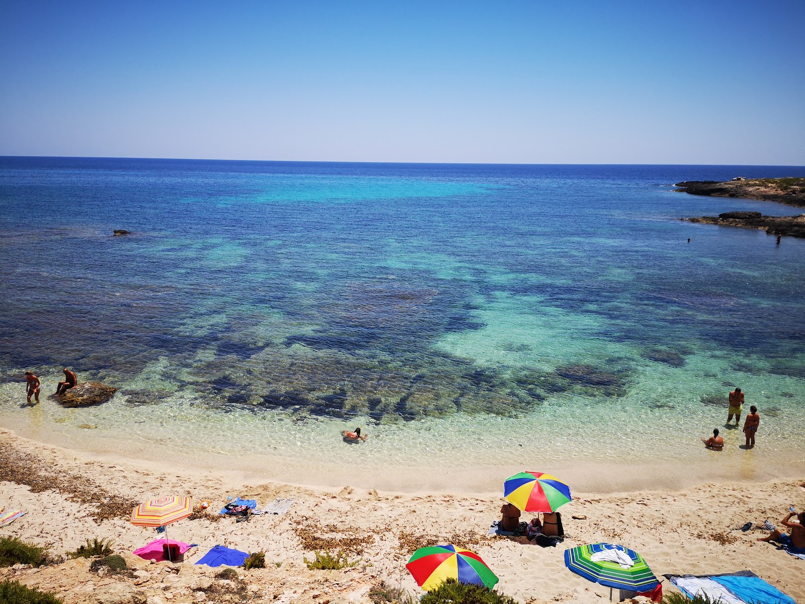 Photo of Cala Spugne with turquoise pure water surface