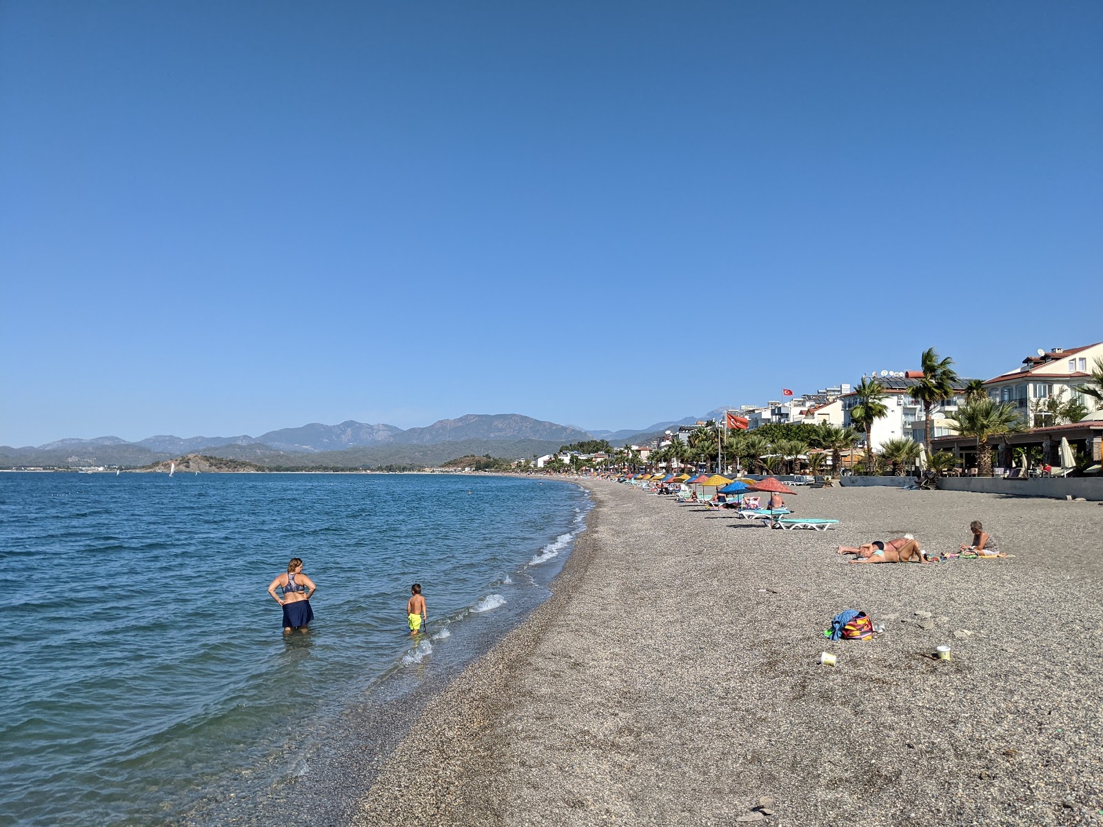 Photo of Calis beach with gray fine pebble surface