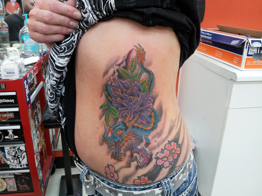 Explore lower back cover up tattoo ideas, creative tattoo ideas in Greeley, available at BLOOD AND IRON TATTOO