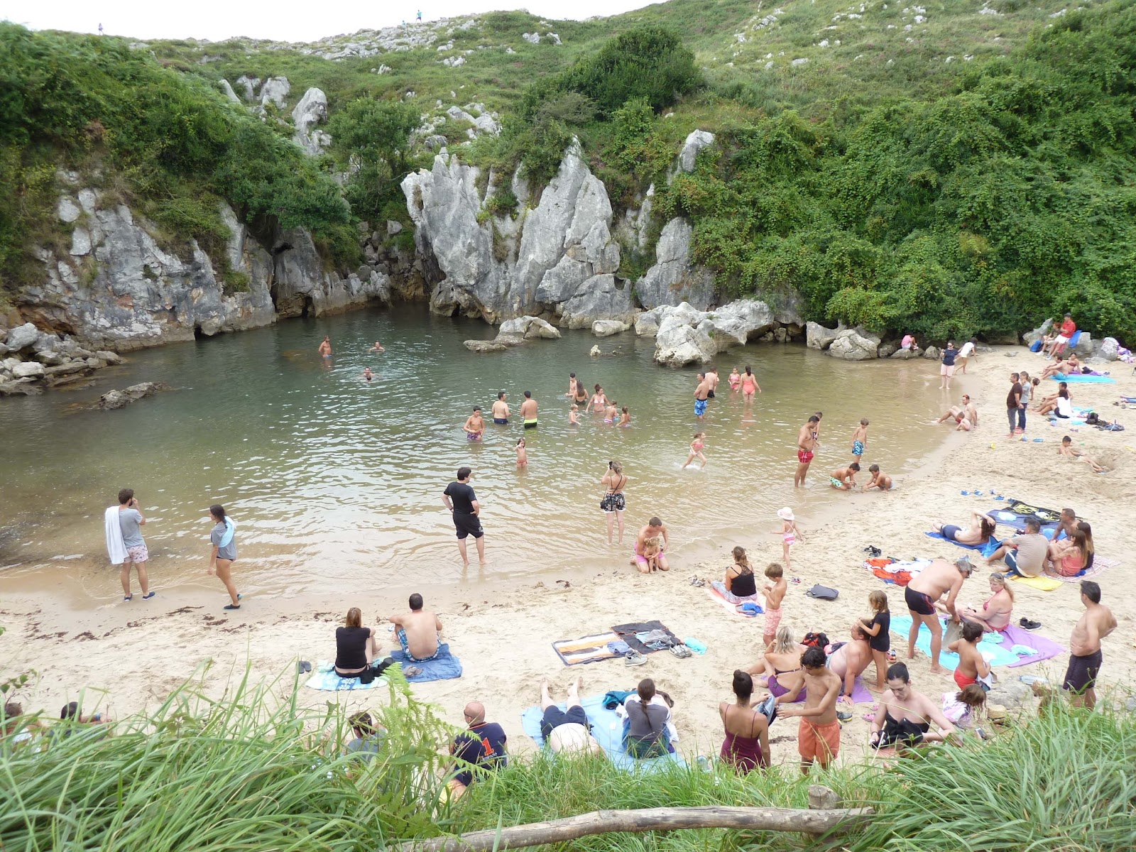 Photo of Playa Gulpiyuri backed by cliffs