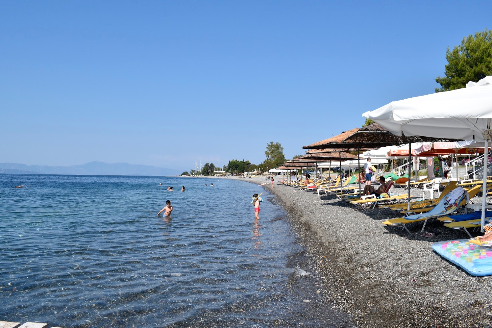 Foto av Koxyli beach med blå rent vatten yta