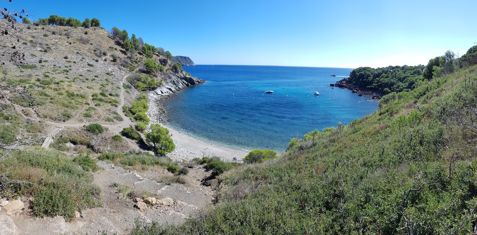 Photo of Platja Cala Murtra with brown sand &  rocks surface
