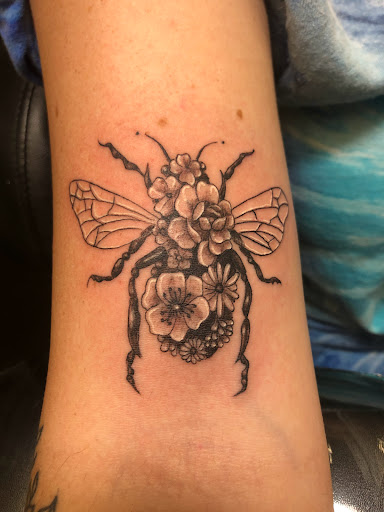 Explore chest tattoo lettering ideas, creative tattoo ideas in Englewood, available at Point of Entry Tattoo