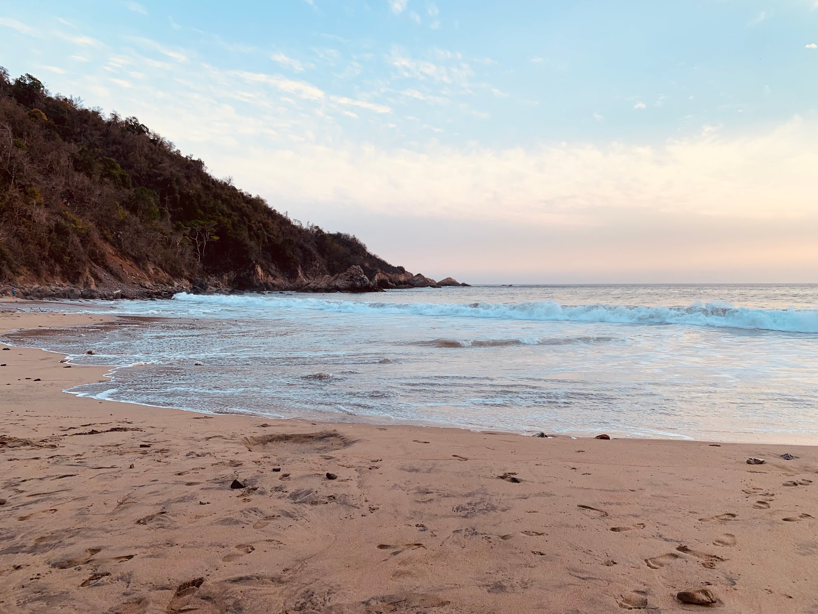 Foto av Playa el Palmito med fin brun sand yta