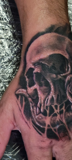 Explore hand tattoo ideas for guys, creative tattoo ideas in Angola, available at Hoodlum Ink