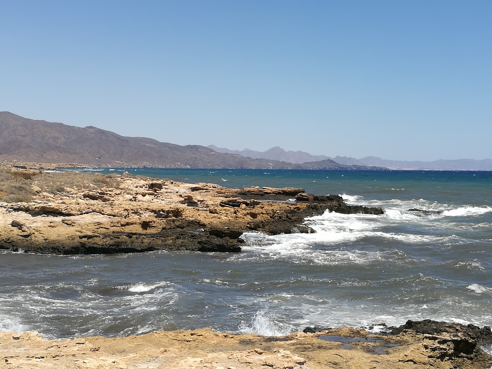 Foto di Playa del Pocico del Animal con una superficie del acqua blu