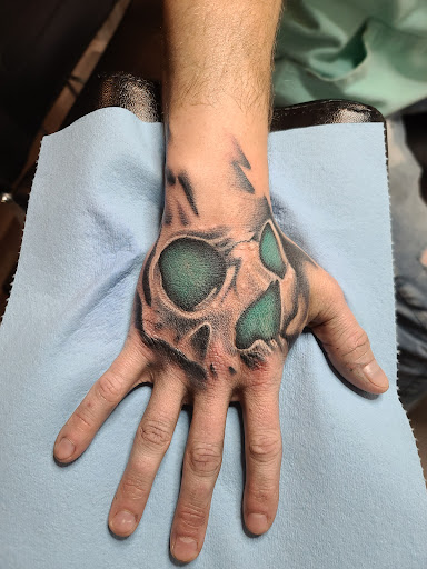 Find tattoo ideas between breast for your next unique tattoo in Clarkston at Rogue Tattoo