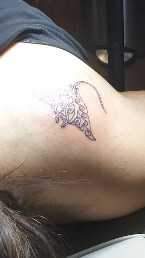 Explore lower back tattoo ideas for men, creative tattoo ideas in Houston, available at Sintown Tattoo Studio