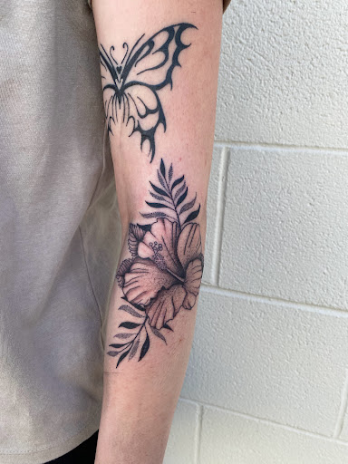 Explore lower arm tattoo ideas, creative tattoo ideas in Topeka, available at Looking Glass Tattoo & Gallery
