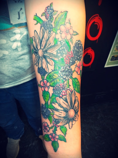 Explore tattoo ideas for women flowers, creative tattoo ideas in Monticello, available at Saints Tattoos