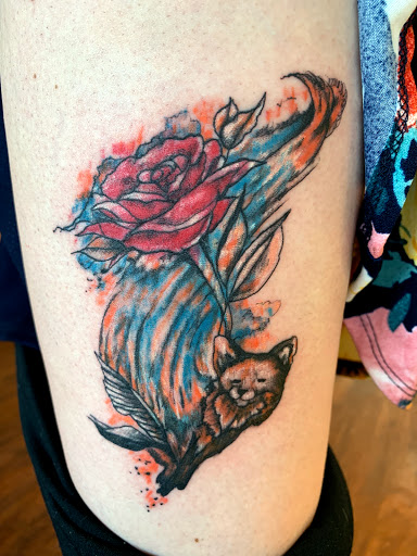 Explore rose thigh tattoo ideas, creative tattoo ideas in Seymour, available at American Gypsy Tattoo Corp.