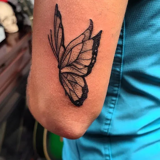 Explore thigh tattoo ideas for men, creative tattoo ideas in Cumberland, available at Queen City Ink