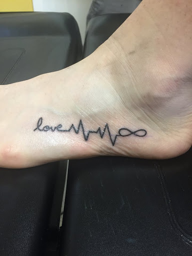 Explore cross tattoo sleeve ideas, creative tattoo ideas in Bossier City, available at Atomic Tattoo