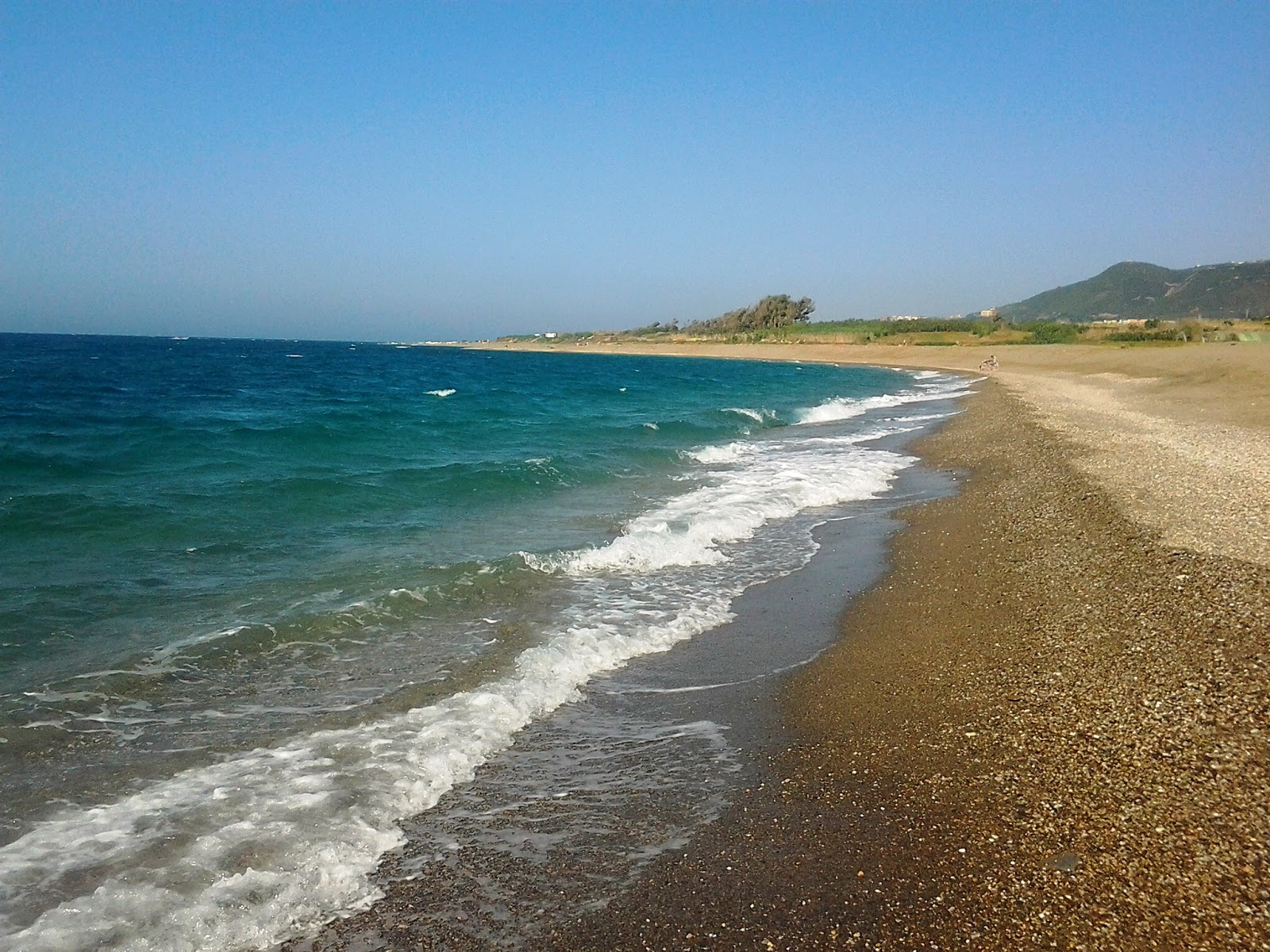 Foto av Plage De Sahel Bouberak med små beige småsten yta