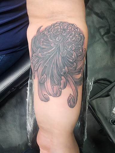 Explore rose hand tattoo ideas, creative tattoo ideas in Peoria, available at Modern Ink Tattoo