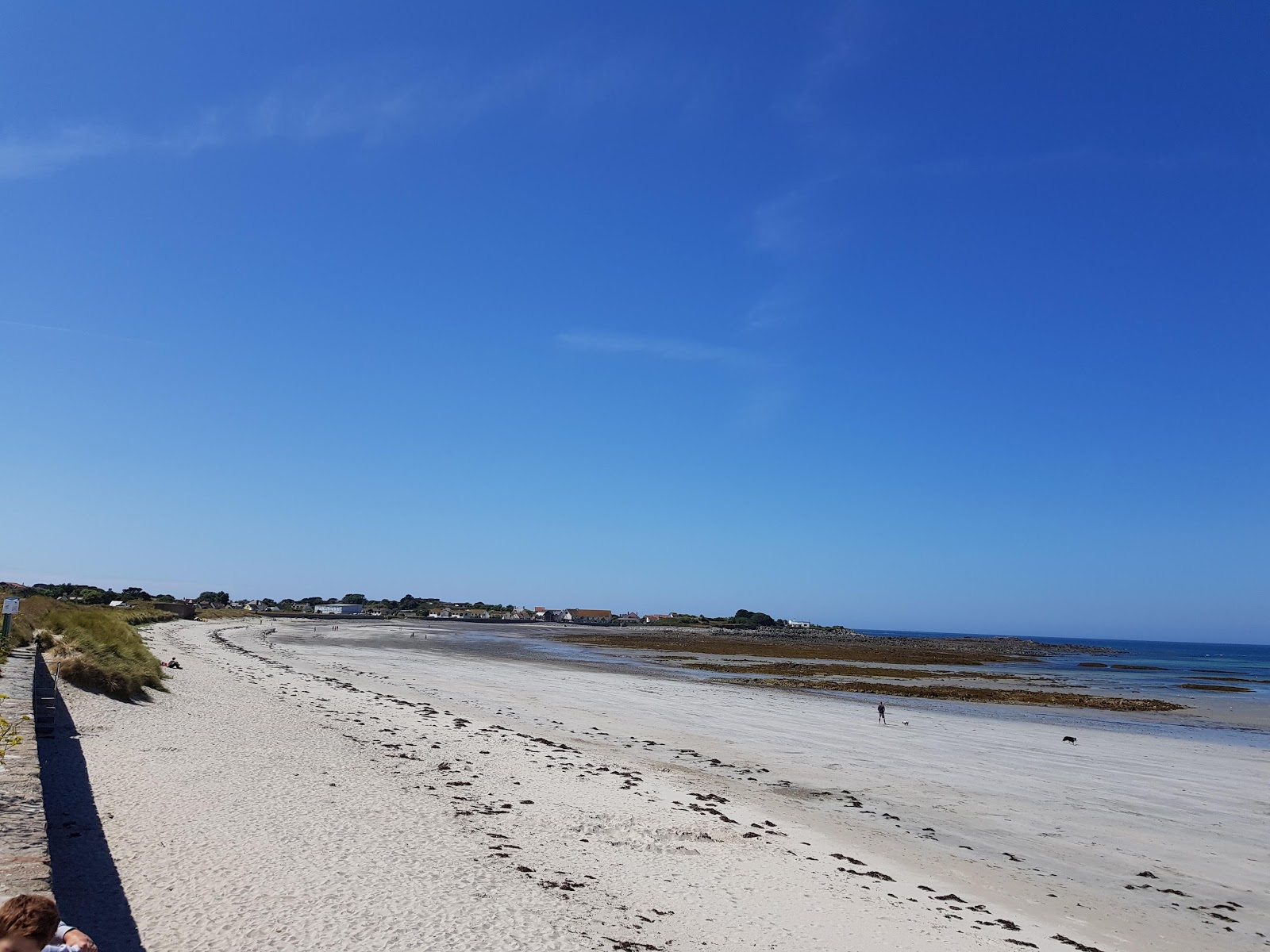 Photo of Vazon Guernsey Beach with bright sand surface