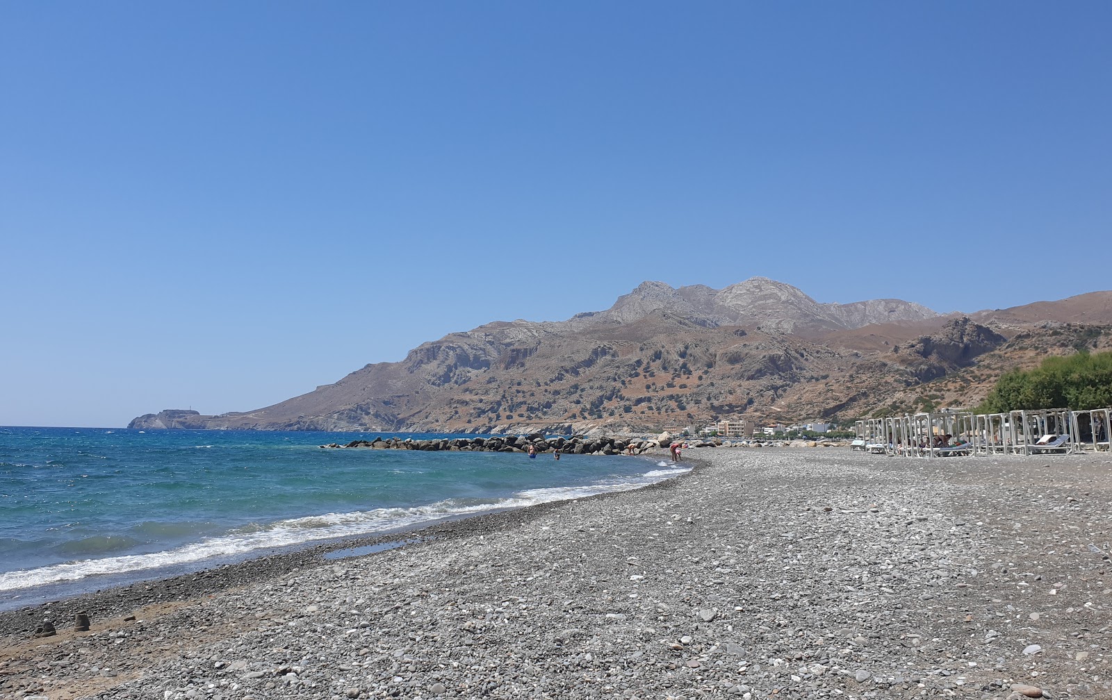 Photo of Tsoutsourou beach with gray sand &  pebble surface