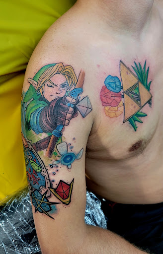 Explore male upper arm tattoo ideas, creative tattoo ideas in Benton, available at Spectrum Tattoo