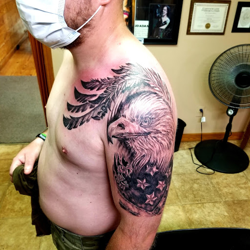 Explore cover up lower back tattoo ideas, creative tattoo ideas in Conway, available at Primal Urge Tattoos