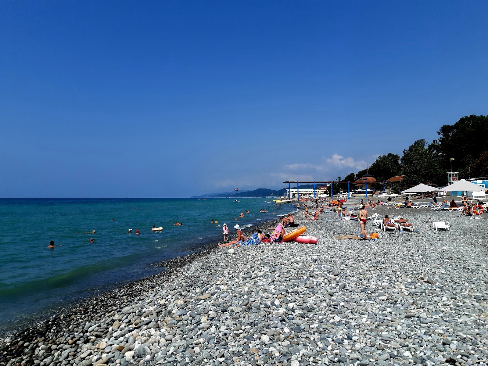 Photo of Loo beach with gray pebble surface