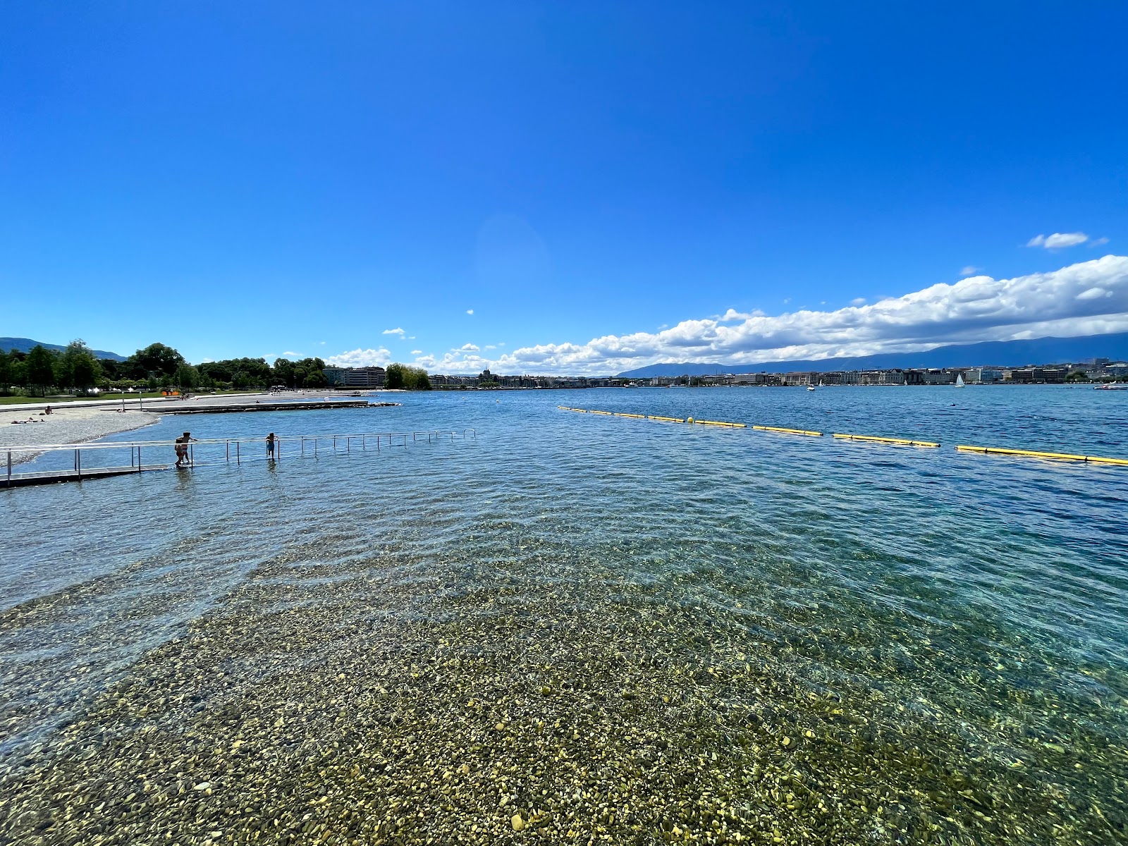 Valokuva Plage des Eaux-Vivesista. pinnalla pienet harmaat kivet:n kanssa